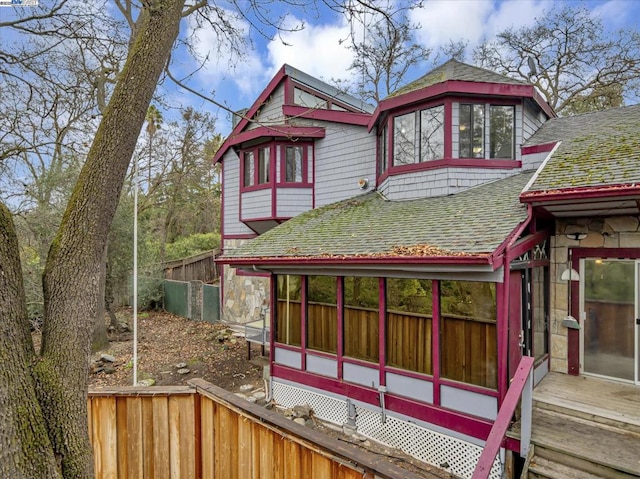 back of house featuring a sunroom