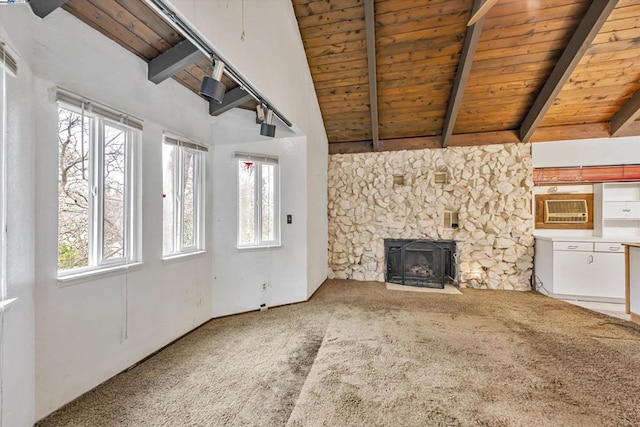 unfurnished living room featuring lofted ceiling with beams, carpet, and wooden ceiling