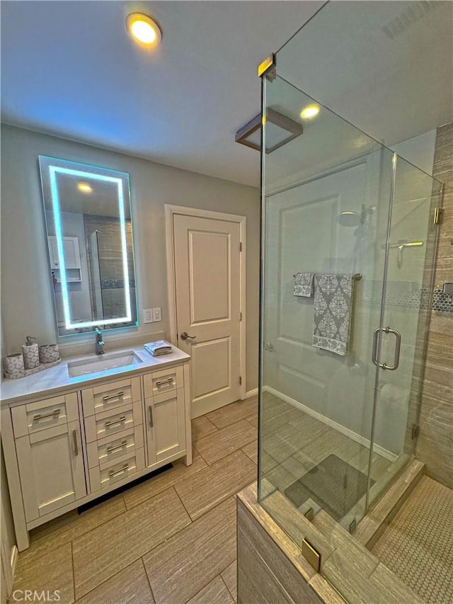 bathroom with vanity and an enclosed shower