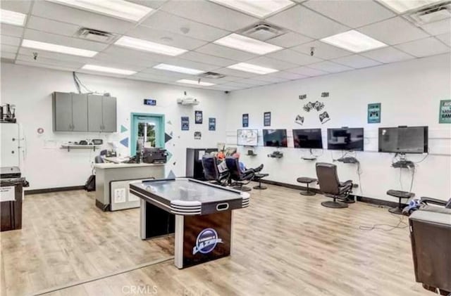 playroom with a drop ceiling and light hardwood / wood-style floors