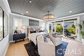 bedroom with access to outside, wood ceiling, and light wood-type flooring