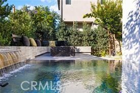 view of pool with pool water feature