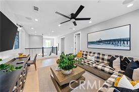 living room with ceiling fan and light hardwood / wood-style flooring