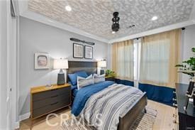 bedroom with crown molding and light hardwood / wood-style flooring