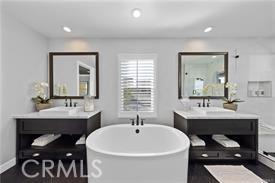 bathroom featuring a bathing tub and vanity