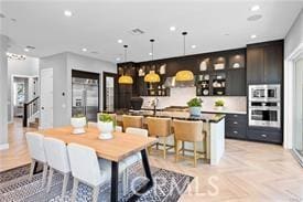 dining space featuring light parquet flooring