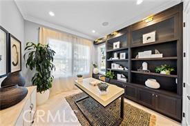 living area featuring crown molding and built in features