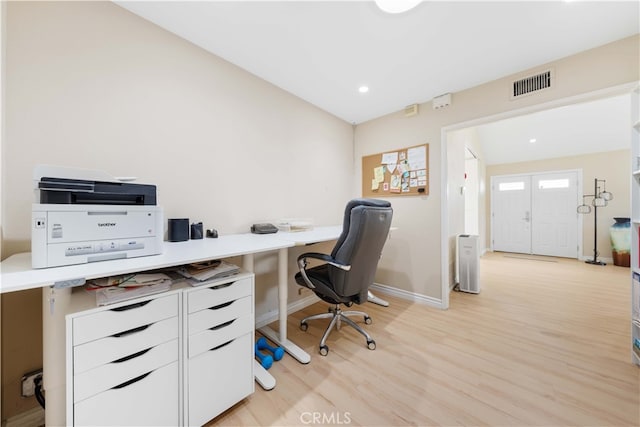 home office with light hardwood / wood-style flooring