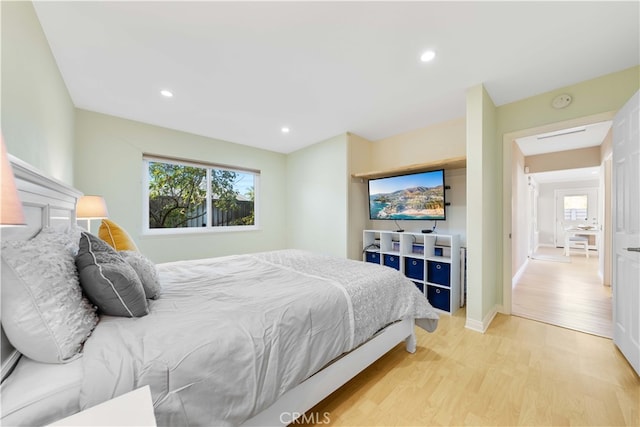 bedroom with multiple windows and light wood-type flooring