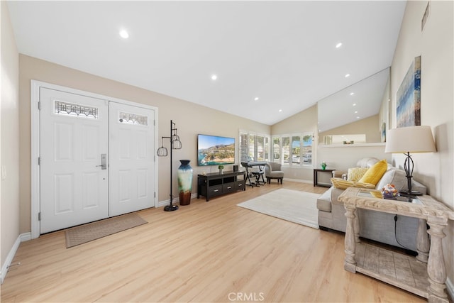 living room with lofted ceiling and light wood-type flooring