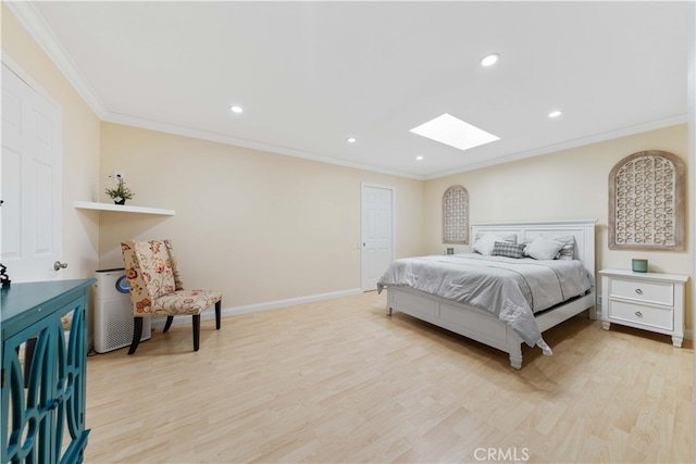 bedroom with ornamental molding, light hardwood / wood-style floors, and a skylight