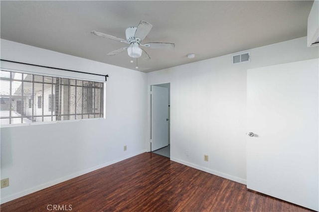 unfurnished room with dark hardwood / wood-style floors and ceiling fan