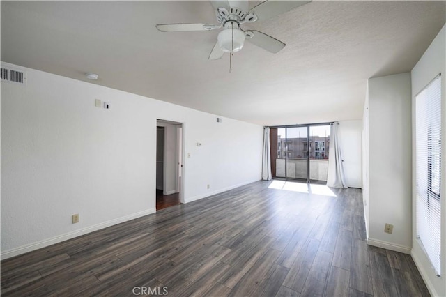 empty room with dark hardwood / wood-style floors and ceiling fan