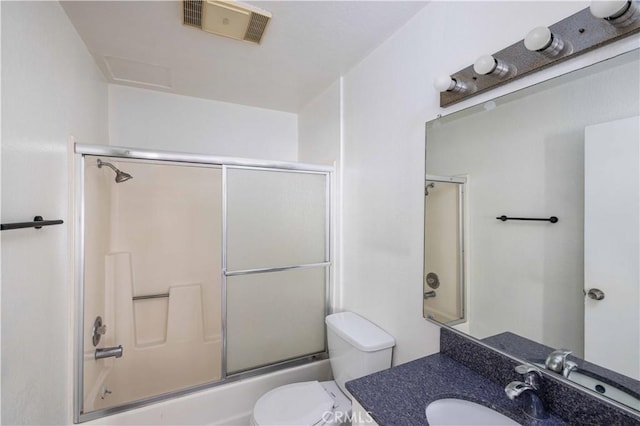 full bathroom with toilet, vanity, and bath / shower combo with glass door