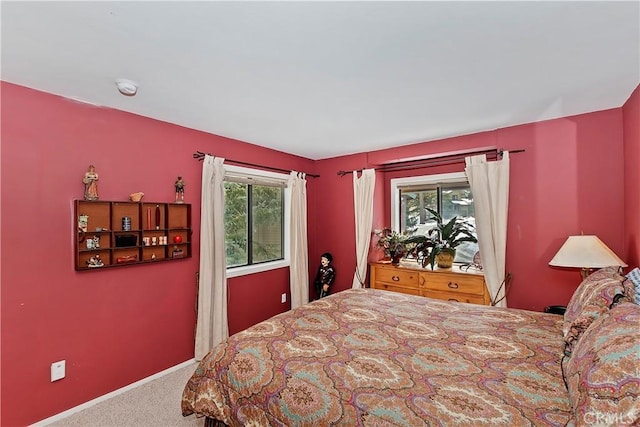 bedroom with multiple windows and carpet flooring