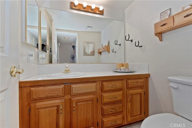 bathroom featuring vanity and toilet