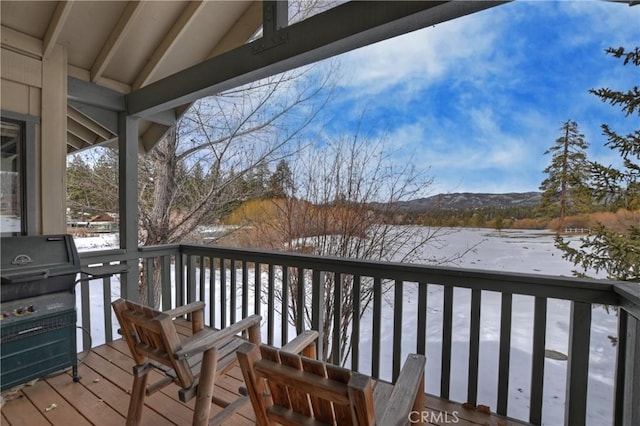 snow covered deck featuring a grill