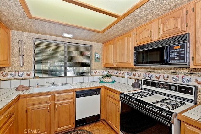 kitchen featuring light parquet flooring, sink, tile countertops, and white appliances