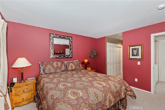 bedroom featuring light colored carpet and a closet