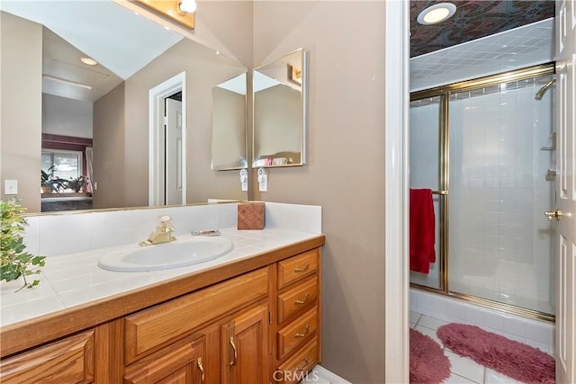 bathroom with walk in shower, vanity, and tile patterned flooring