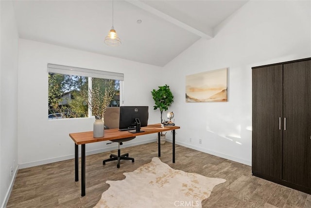 office space featuring lofted ceiling with beams, baseboards, and wood finished floors