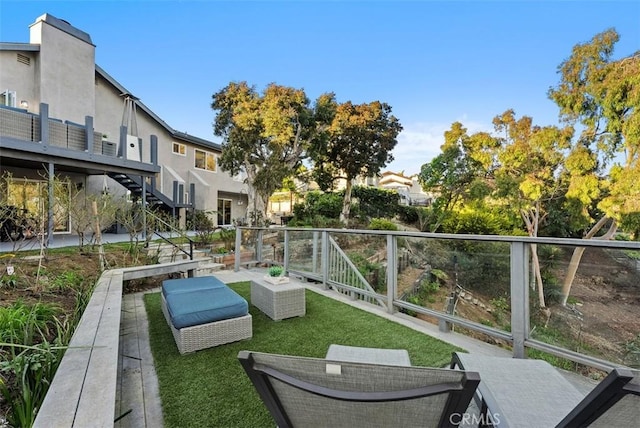 view of property's community featuring stairs and a lawn