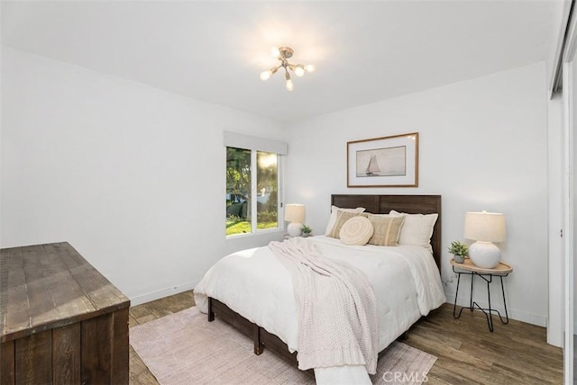 bedroom featuring baseboards and wood finished floors