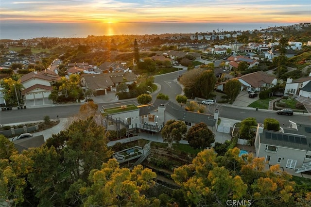 drone / aerial view with a water view and a residential view