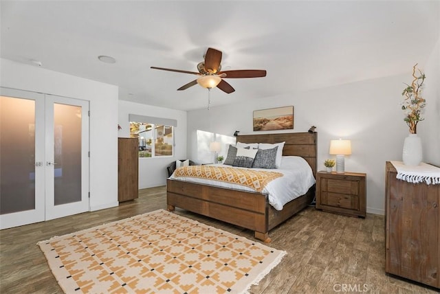 bedroom featuring ceiling fan, wood finished floors, and french doors