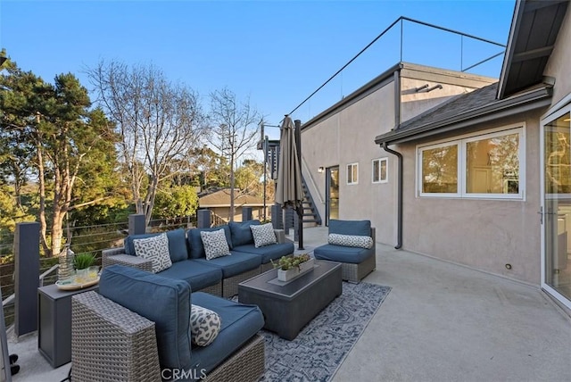 view of patio featuring stairs and an outdoor living space