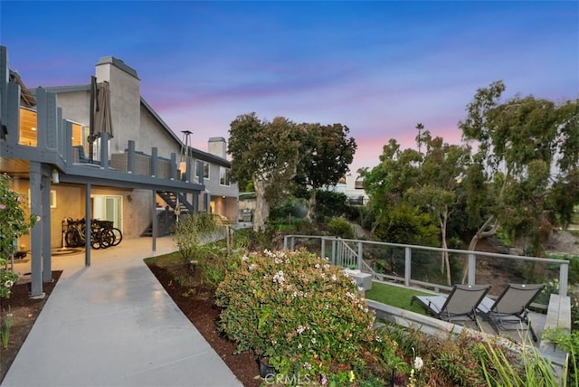 view of home's community with a patio area and fence