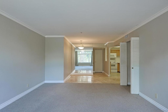 unfurnished room with light carpet and crown molding