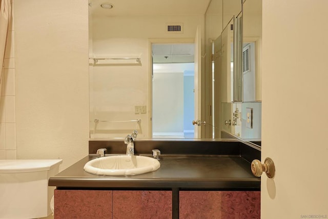 bathroom with vanity and toilet