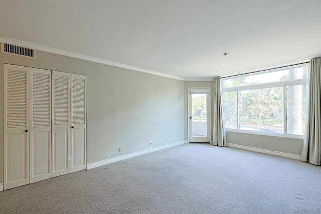 interior space with crown molding and light colored carpet