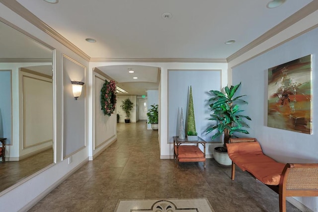 hallway with ornamental molding and dark tile patterned floors