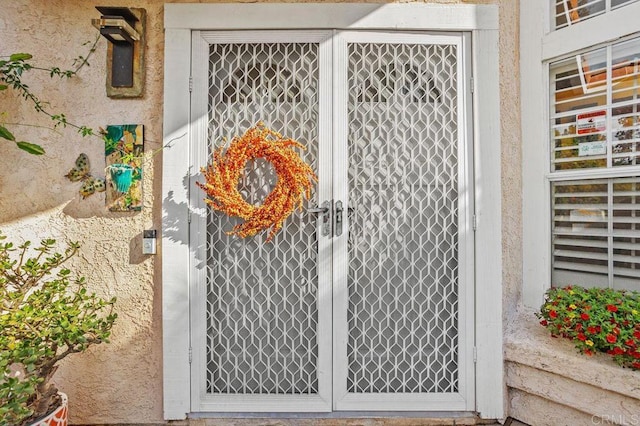 view of exterior entry featuring french doors