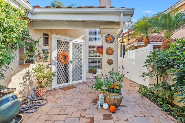 entrance to property with a patio area and stucco siding