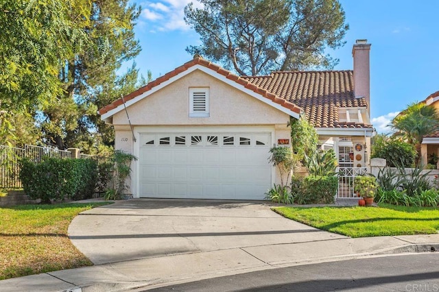 view of front of property with a chimney, stucco siding, fence, driveway, and a tiled roof