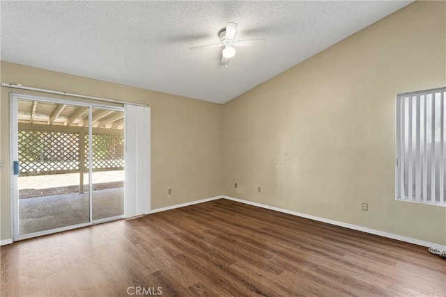 unfurnished room with vaulted ceiling, hardwood / wood-style floors, ceiling fan, and a textured ceiling