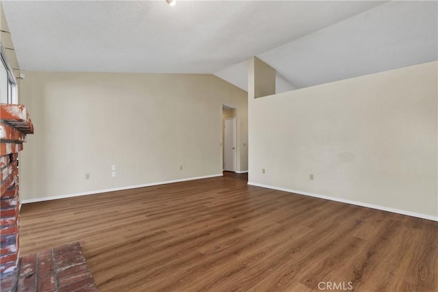 unfurnished living room featuring dark wood-type flooring and lofted ceiling