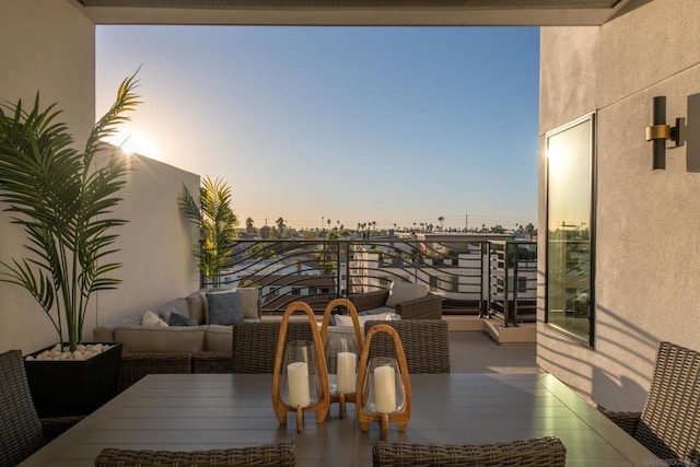 balcony at dusk featuring outdoor lounge area