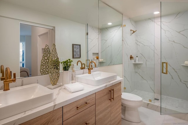 bathroom featuring vanity, an enclosed shower, and toilet