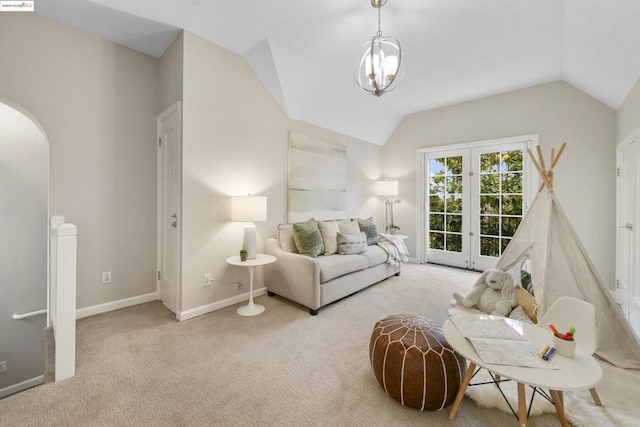 carpeted living room featuring lofted ceiling and a chandelier