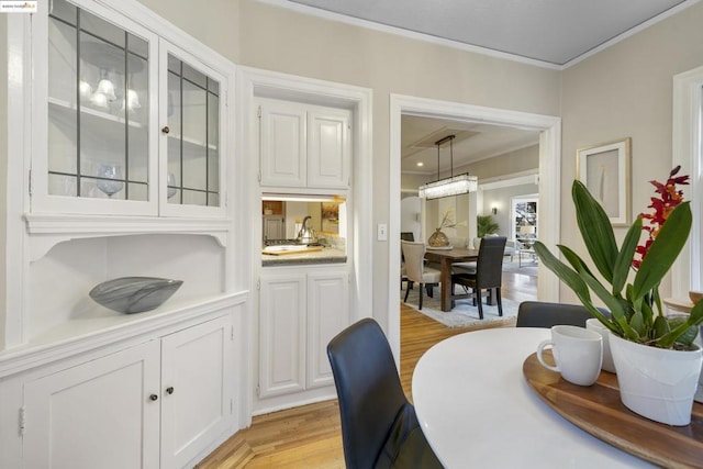 dining room featuring crown molding and light wood-type flooring