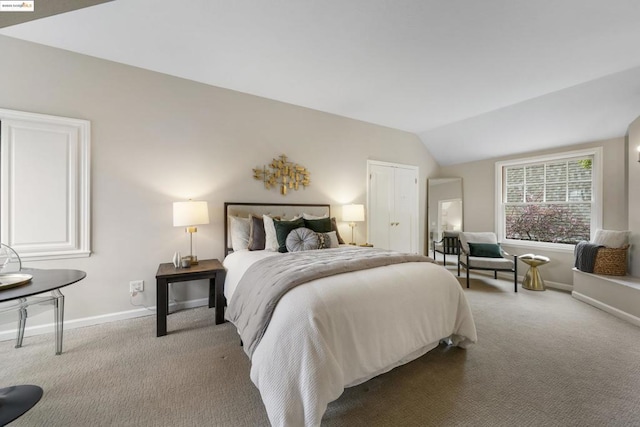 carpeted bedroom with vaulted ceiling