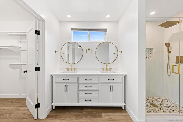 bathroom with an enclosed shower, hardwood / wood-style floors, and vanity