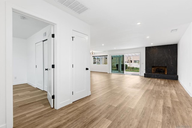 unfurnished living room featuring a fireplace and light wood-type flooring