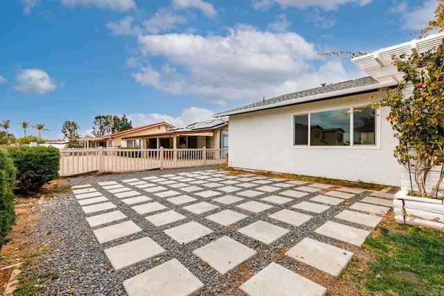 exterior space with a patio and solar panels