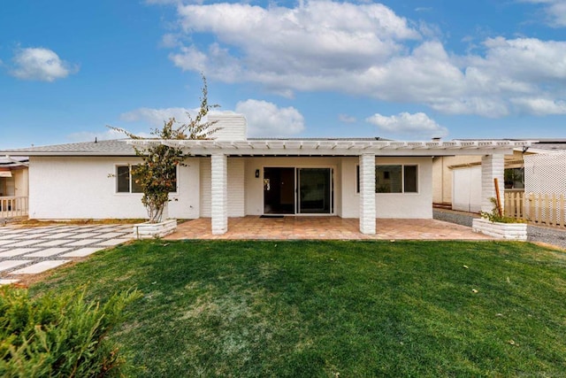 rear view of house with a patio area and a lawn