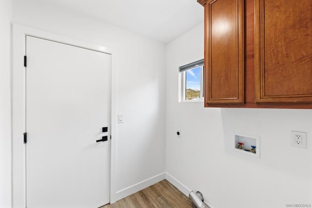 washroom with cabinets, hookup for a washing machine, electric dryer hookup, and light hardwood / wood-style flooring